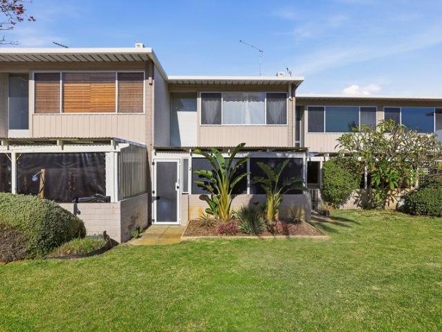 CAREFREE COMFORT WITHIN A PREMIUM COASTAL SETTING, WITH A DUAL LEVEL TOWNHOUSE DESIGN