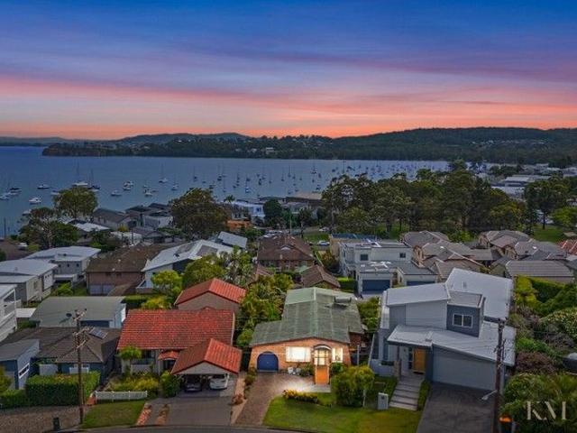 Cathedral Ceilings, Lake Views and Rear Lane Access in Prime Location