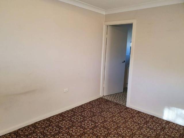 CENTRAL LOCATION THIS TIDY RESIDENTIAL FLAT WITH ITS OWN CARPORT