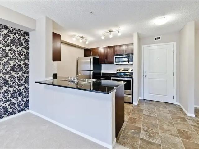 Charming 2 Bed, 2 Bath Condo with Den, Underground Parking in Airdrie — 2 Bedrooms+ Den Condo Unit