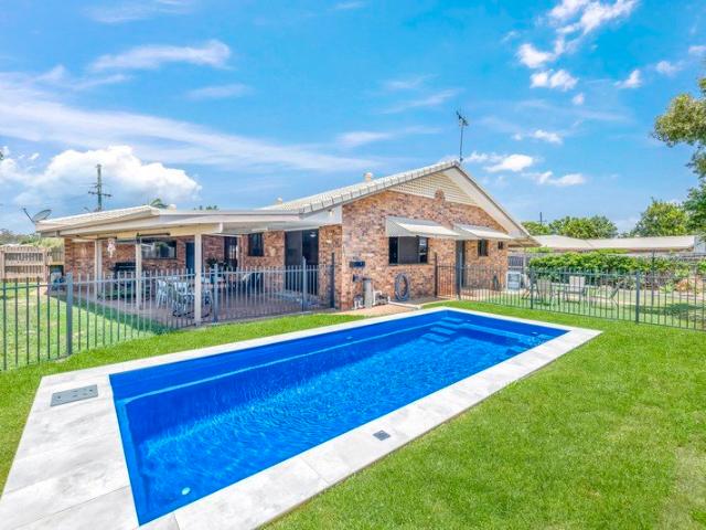 Charming Brick Home with a Pool: Perfectly Positioned for Family Living and Entertaining!