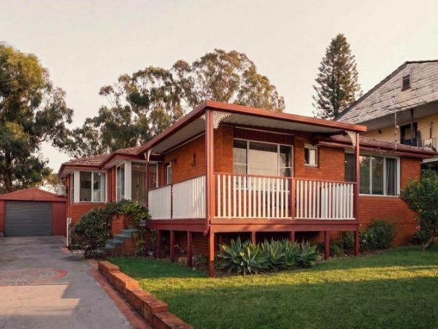 Charming Brick Home with Spacious Interiors and Lush Gardens