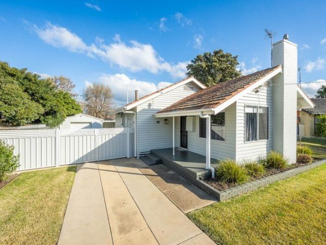 Charmingly renovated home with additional powder room, manicured gardens, secure yard and lock up garage!