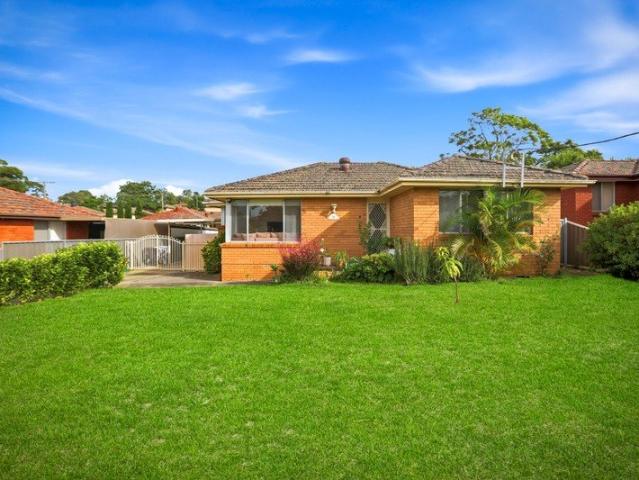 Comfortable Brick Family Home with Oversized Sunroom and Spacious Outdoor Living
