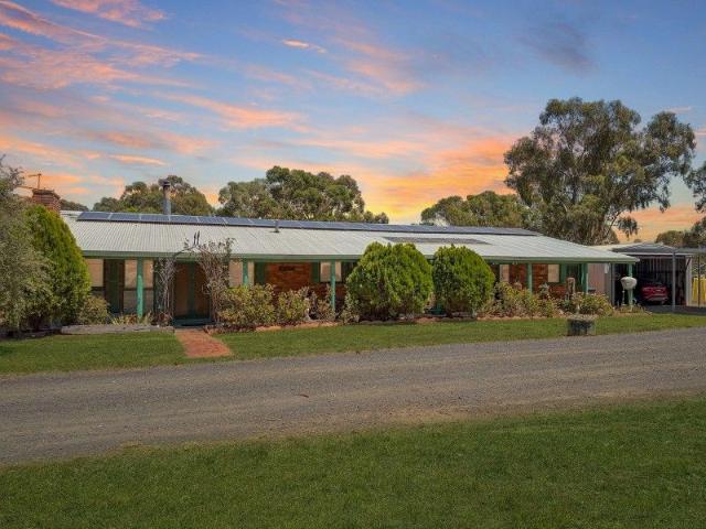 COMFORTABLE BRICK HOME EXPANSIVE ACERAGE RURAL LIVING AT ITS BEST