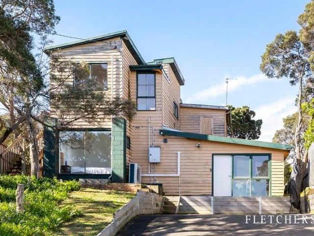 Coastal opportunity with bay glimpses and big potential