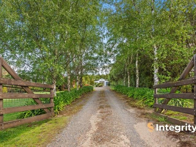 Peaceful Acreage Living Wrapped in Lush Gardens