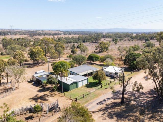 COUNTRY LIVING WITH EXTENSIVE SHEDDING & WATER ON 7 ACRES