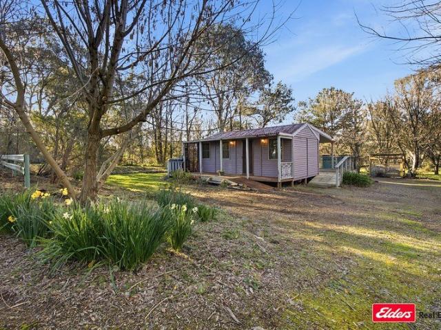 Cute as a button cottage surrounded by a large established garden