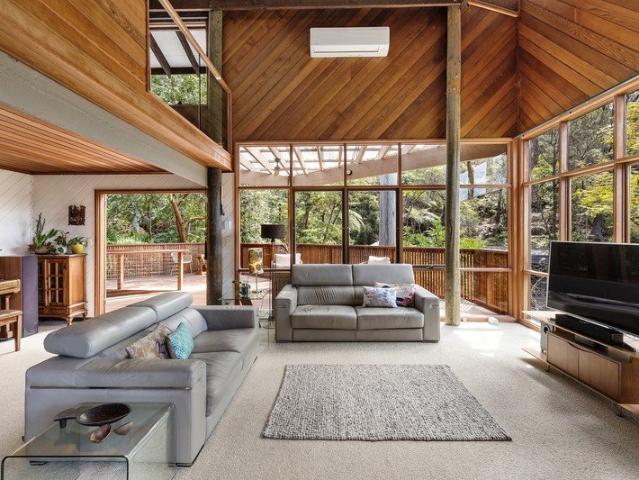 Elevated tri level architectural gem in peaceful natural setting