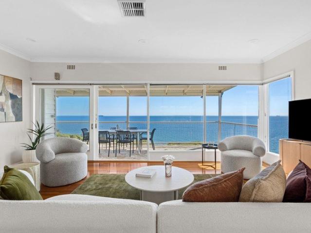 ELEVATED WATERFRONT LIVING WITH UNINTERRUPTED BAY VIEWS AND APPROVED PLANS