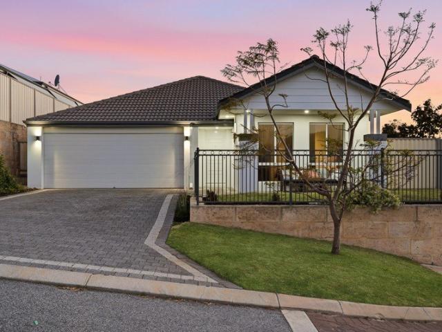 ELEVATED COASTAL HOME WITH A PREMIUM CORNER SETTING THAT'S JUST SECONDS FROM PARKLAND