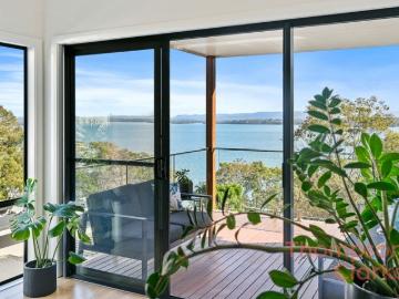 Elevated Lakeside Living with Stunning Views & Multiple Entertaining Decks
