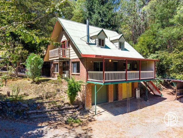 ENCHANTING STORY BOOK LIKE HOME OVER HALF AN ACRE FRONTAGE ONTO ARMSTRONG CREEK