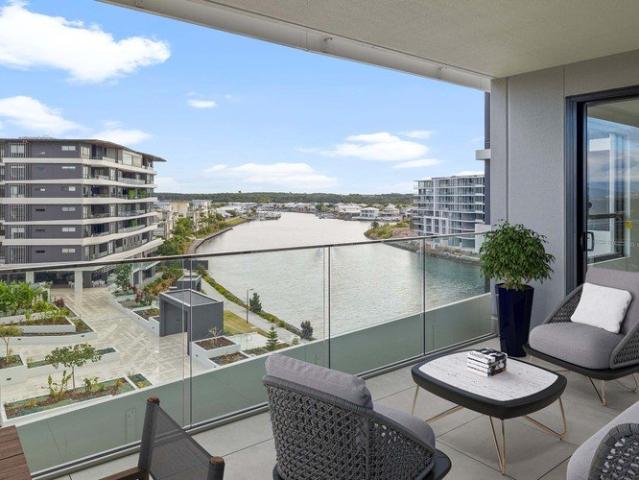 Enjoy views over the landscaped gardens and water