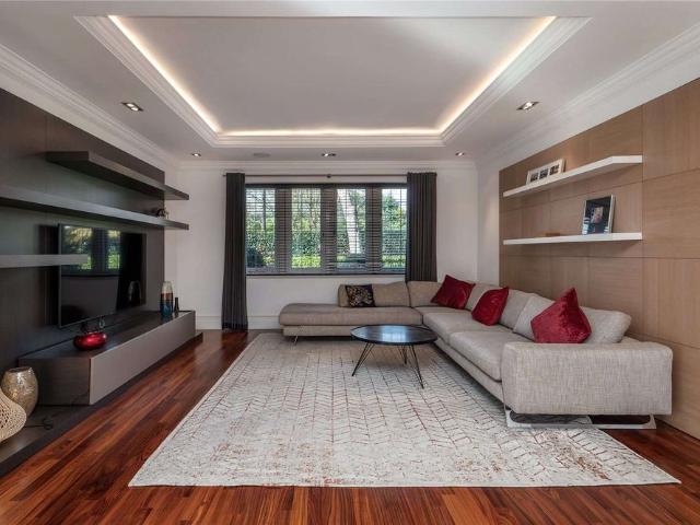 Exceptional gated residence extending to approximately 8,200 sq ft, set within mature landscaped grounds of over half an acre
