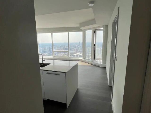 Exclusive & Rare SW Corner Suite — 2 Bedrooms+ Den Condo Unit