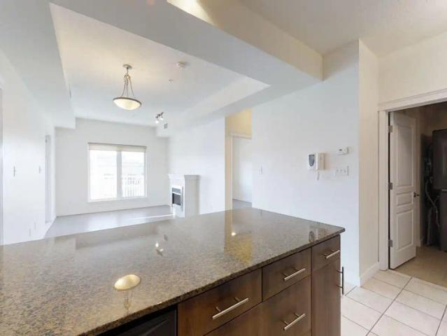 Executive Fourth Floor Unit Across From MacEwan With 2 Parking Stalls! — 2 Bedrooms Condo Unit