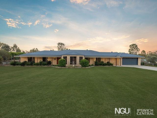 EXPANSIVE ACREAGE LIVING WITH FIVE BEDROOMS, THREE BATHROOMS AND EXCEPTIONAL SHED SPACE