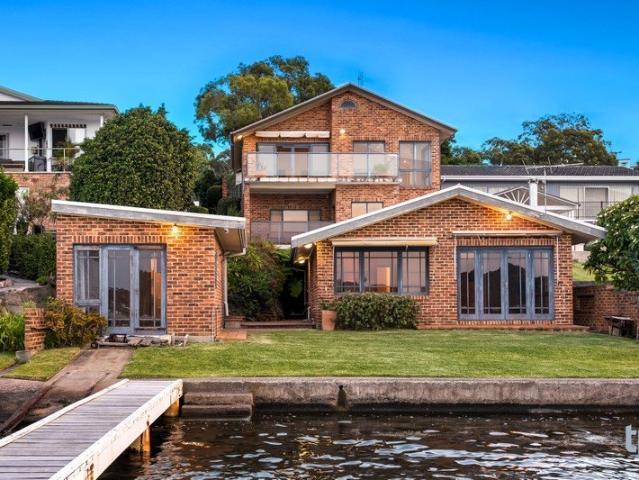 Expansive Lakefront Escape with Private Jetty