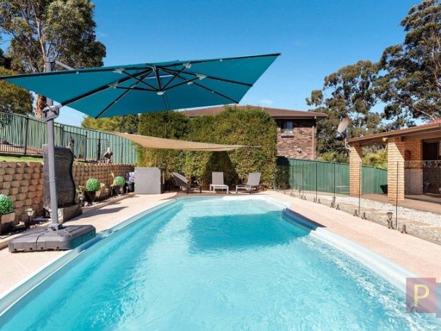 FAMILY HOME WITH VERSATILE LIVING SPACES & POOL