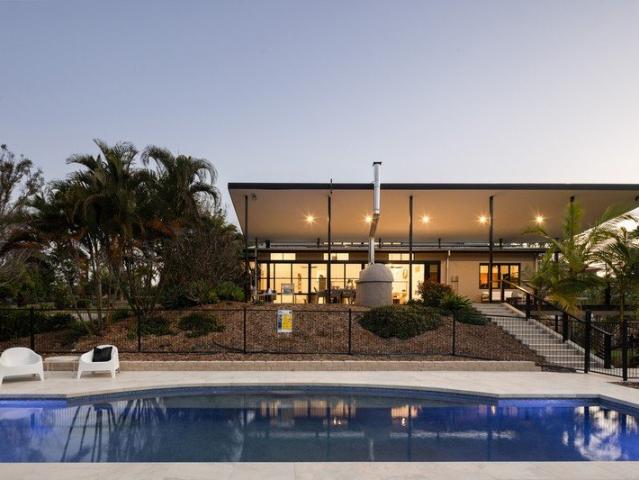 First Time Offered: Prestigious Eatons Hill Acreage with Resort Style Pool and Architectural Design