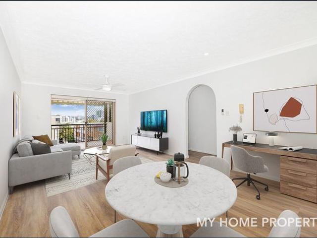 Freshly painted and new floor top floor unit with city views