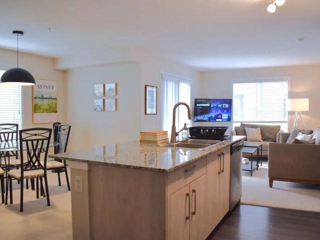 FULLY FURNISHED 2 bedroom + den, 2 bath corner unit in NE Calgary — 2 Bedrooms+ Den Condo Unit