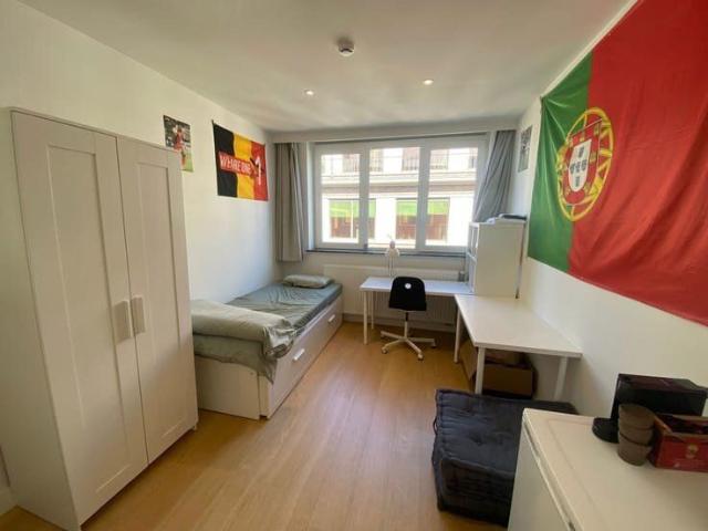 Furnished student room with shared bathroom facilities