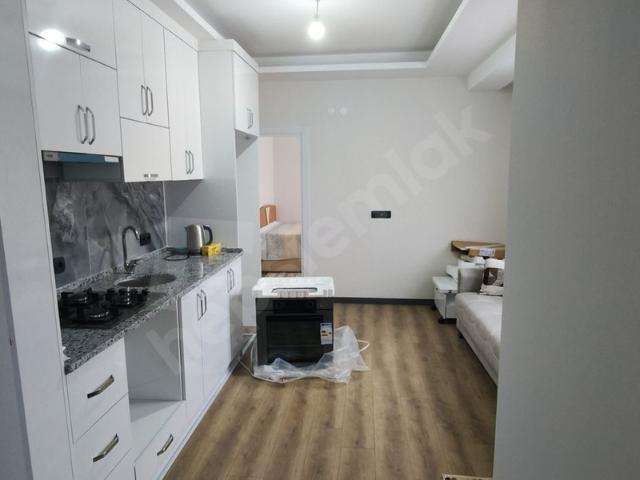 GARANTİ EMLAK'tan MERKEZİ KONUMDA 1+1 SIFIR EŞYALI