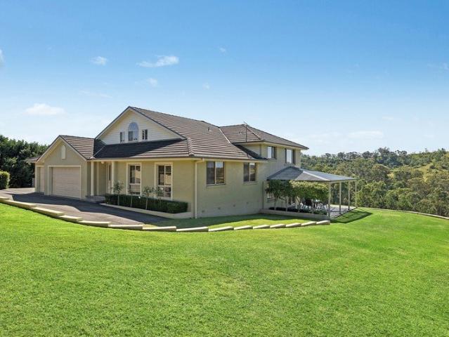 Grand homestead with a vineyard backdrop
