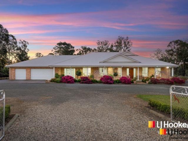 Grand Scale Acreage Living with Custom Designed Home & Serious Shedding