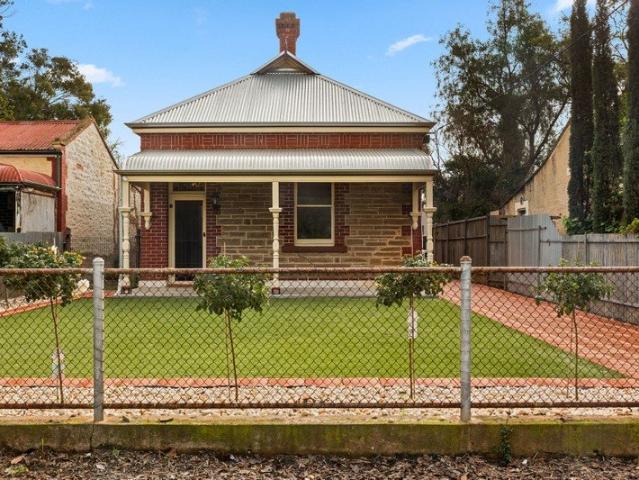 Beautifully Renovated Heritage Home with Secure Parking and Low Maintenance Living