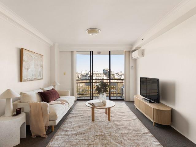 High floor inner city apartment with treetop views and secure parking