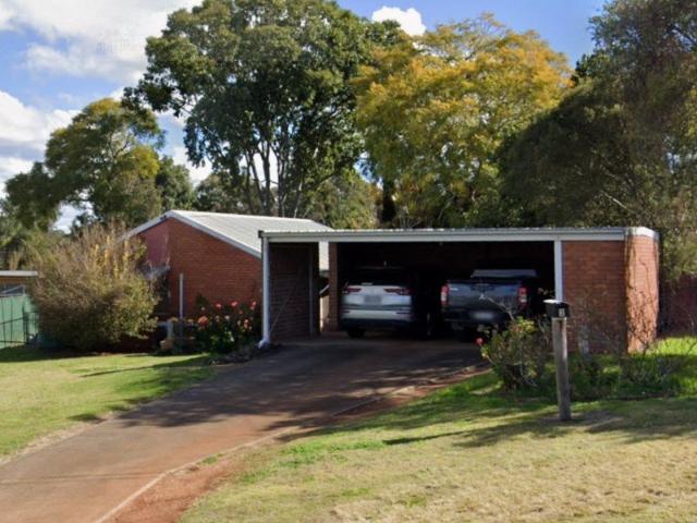 Home on the hill with multiple living areas and plenty of potential