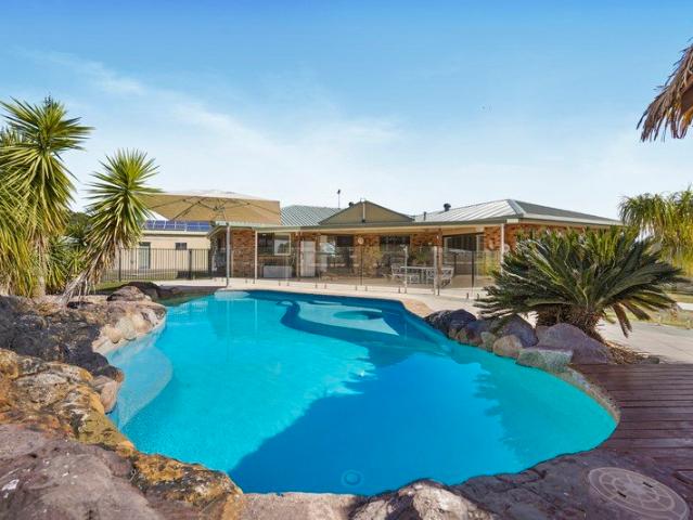Immaculate Acreage Oasis with Resort Style Living
