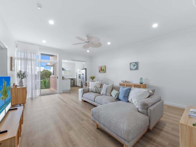 Immaculate Top Floor Apartment with Coastal Styling & Stunning Pool Views