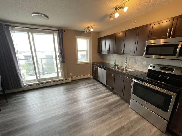 Internet & Heated Underground Parking Included, Steps to T&T & Walmart — 1 Bedroom+ Den Condo Unit