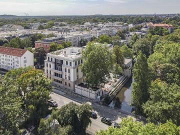 Kleines Mehrfamilienhaus mit Mietergärten und Stellplätzen