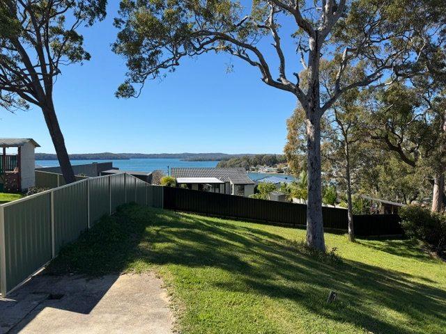 Large sloping bushland block with water views