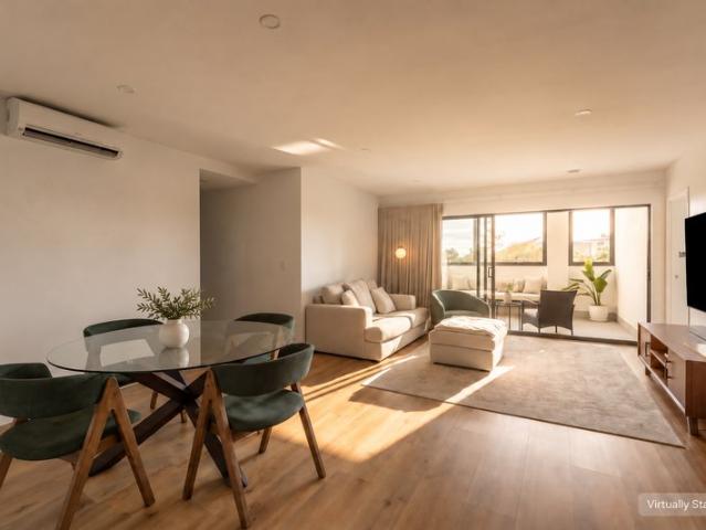 Light Filled Living with an Oversized Enclosed Balcony