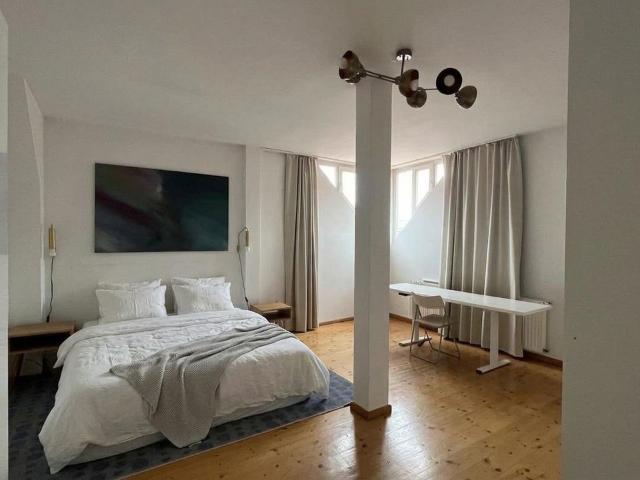 Light filled top floor apartment in a period building with wooden floorboards and charming sloped ceilings, Berlin Amsterdam Apartments for Rent