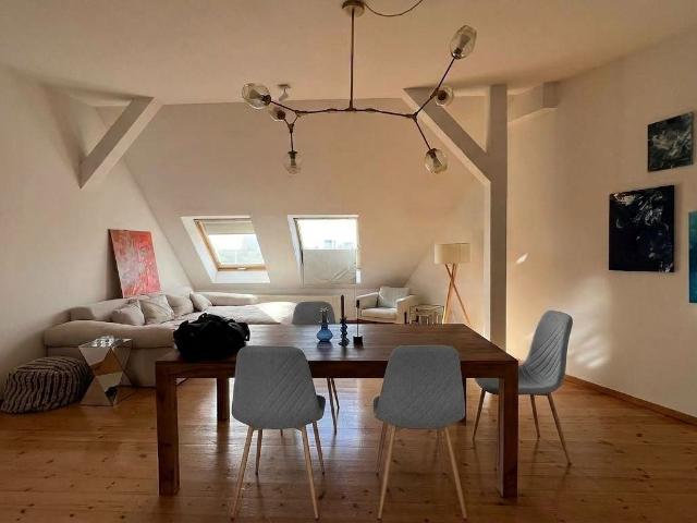 Light filled top floor apartment in a period building with wooden floorboards and charming sloped ceilings
