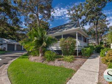 Live Where You'd Love to Holiday, Resort Style, in a Completely Freestanding Rarely Offered Architecturally Striking Cottage with Wrap around Deck!