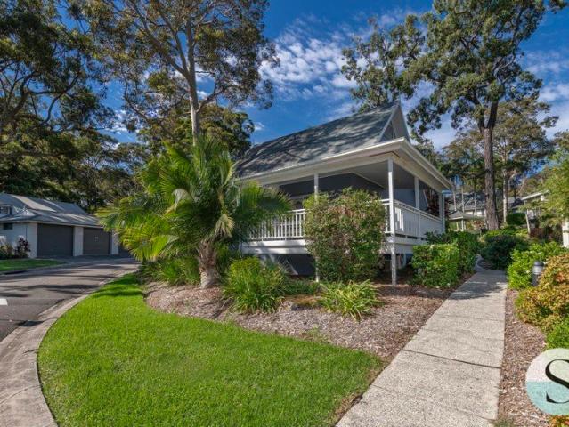 Live Where You'd Love to Holiday, Resort Style, in a Completely Freestanding Rarely Offered Architecturally Striking Cottage with Wrap around Deck!