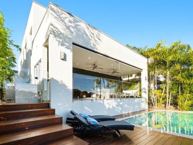 Luxurious waterfront 5 star family home located within the secure and safe area of Hope Island Resort. Read on!