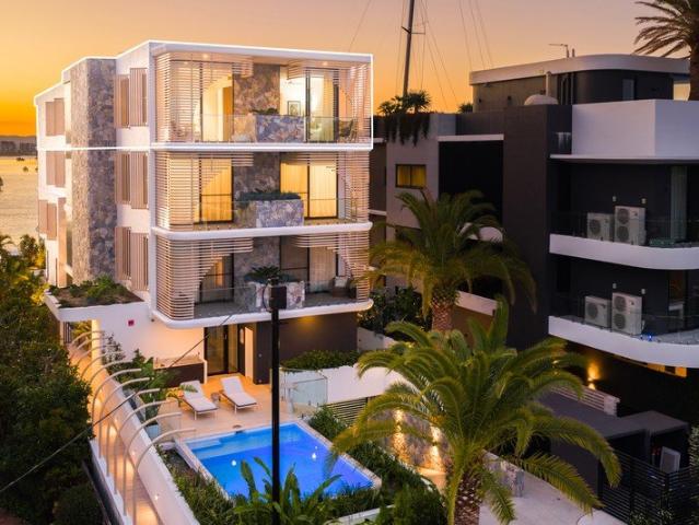 Luxurious Top Level Waterfront Living with Panoramic Views