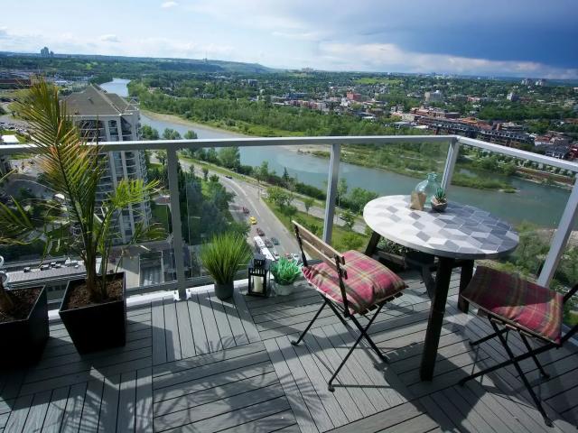 Luxury furnished sub penthouse with stunning river and mountain views — 2 Bedrooms+ Den Condo Unit