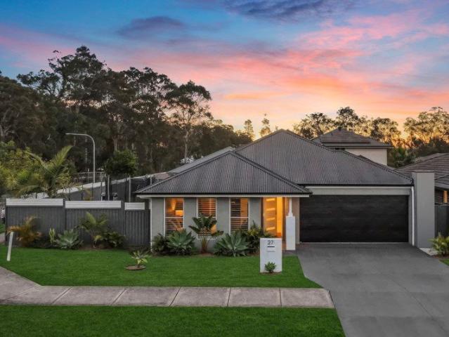 McDonald Jones residence with a brilliant yard