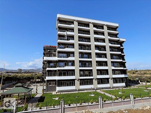 MEZİTLİ KİRALIK ANAYOLA YAKIN GENİŞ BALKONLU SIFIR 1+1 DAİRE
